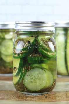 pickled cucumbers in a mason jar on a cutting board