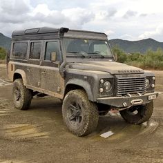 a black and white photo of an old land rover