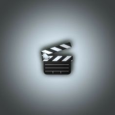 an image of a movie clapper on a gray background with light coming from it