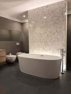 a large white bath tub sitting inside of a bathroom