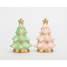 two small ceramic christmas trees sitting next to each other