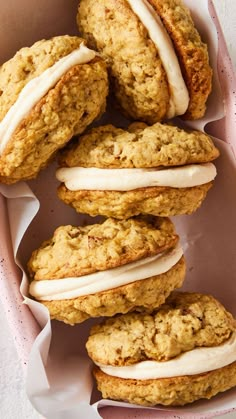 some cookies with icing are in a pink box