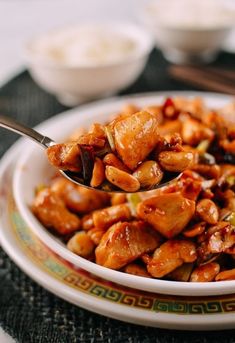 a spoon full of food sitting on top of a plate