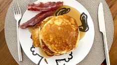 a plate with pancakes and bacon on it