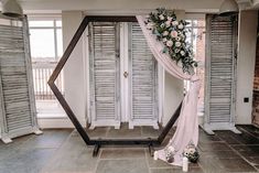 a wedding arch decorated with flowers and greenery