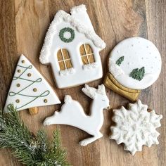 decorated christmas cookies sitting on top of a wooden table