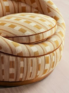 three circular chairs sitting on top of a wooden floor