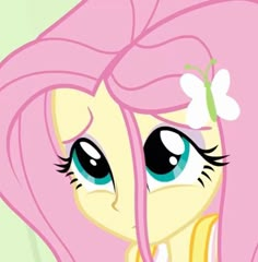 a pink pony with long hair and blue eyes is looking at something in the distance