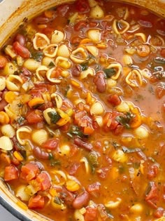 a pot filled with pasta and vegetables on top of a stove