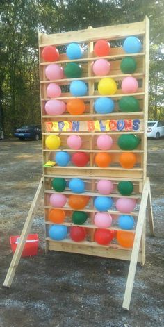 a wooden rack with many different colored balls in it