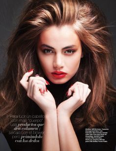 a woman with long brown hair and red lipstick posing for a magazine cover photo shoot