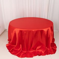 a round table with a red cloth draped over it