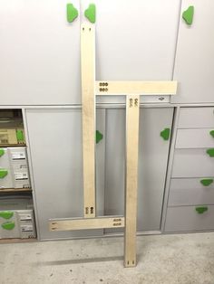 two pieces of plywood sit in the middle of a workbench with green pegs on it