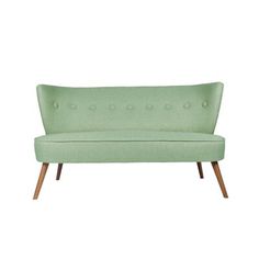 a light green couch with wooden legs and buttons on the back, against a white background