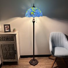 a lamp that is next to a chair