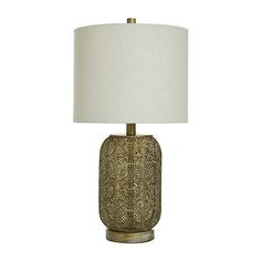 a table lamp with a white shade on the top and gold trimming around it