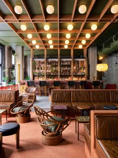 the bar is decorated with wicker chairs and leather couches, along with other furniture