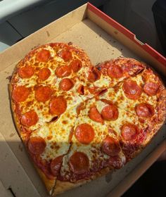 a heart shaped pepperoni pizza in a box