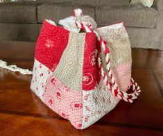 a red and white bag sitting on top of a wooden floor