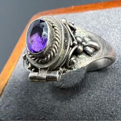 Condition: Pre-Owned / Good Condition Metal: Sterling Silver Ring Style: Applied Floral Scroll Silver Work Around Oval Amethyst With Small Hidden Compartment Hinged Top Poison Ring Stone Type: Amethyst Markings: 925 Stone Size: 6mm X 4mm Ring Size: 7.5 Item Weight: 3.1 Grams Poison Ring, Ring Stone, Silver Work, Ring Style, Ring Size 7, Womens Jewelry Rings, Sterling Silver Ring, Locket, Fashion Rings