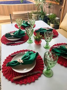 the table is set with green and red place settings