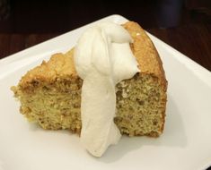 a piece of cake with icing on a white plate