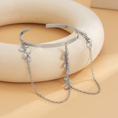 Make a statement with this silver-plated arm cuff decked with shell tassel and chain loops. Cuff: 3" diameter Chain: 6.2" L Silver-plated copper Luxury Accessories Woman, Arm Bracelets Upper, Arm Bracelets, Chain Loop, Cuff Jewelry, Cuff Bangle Bracelet, Arm Cuff, Metal Bracelets, Cuff Bangles