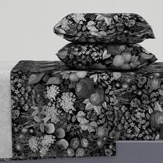 black and white photograph of three pillows stacked on top of each other