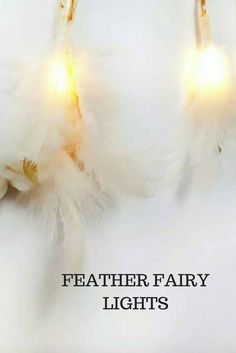 three white feathers with yellow lights on them and the words feather fairy lights above it