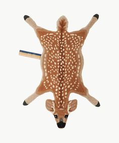 a stuffed deer head hanging from the ceiling with two pencils in it's mouth