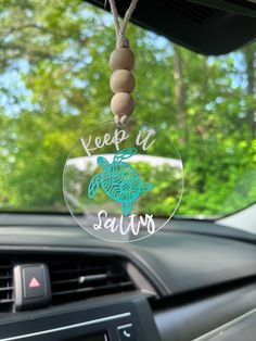 a car dashboard with a key chain hanging from it's center console and the words keep it salty