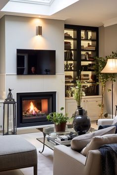 a living room filled with furniture and a fire place in the middle of it's wall