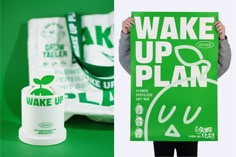 a person holding up a green sign next to a cup and napkin on a table