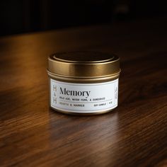 a close up of a jar on a table with a wooden surface in the background