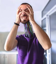 a man holding his hands to his face and covering his eyes with the other hand