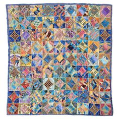 an old quilt with many different colors and patterns on it's sides, including the blue