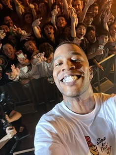 a man is taking a selfie in front of an audience