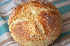 a loaf of bread sitting on top of a striped cloth