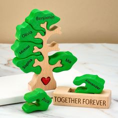 a wooden toy tree with the names of its branches on it and two other toys