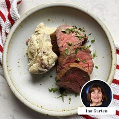 a white plate topped with steak and mashed potatoes next to a woman's face