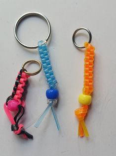 two key chains with different colored beads on them