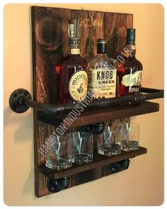 a wooden shelf with bottles and glasses on it