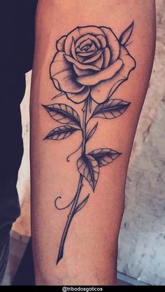 a black and white rose tattoo on the arm