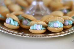 some cookies with blue and pink frosting on a plate