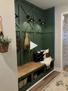 the entryway is decorated with green paneling and hanging baskets on it's hooks