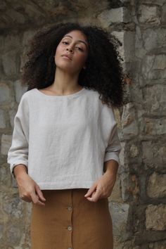 "SIZES Washed linen crop top with long sleeves. This top is perfect to wear with any skirt or pants. It fits very comfortably over the head and has no closures. It is made with high quality washed linen and handmade in Spain. DETAILS Oeko-Tex certified quality guarantee. 100% European linen ( Belarusian )of the best quality of a medium weight (185gr) This linen is washed and softened to have a nice touch. Linen is an ecological and breathable fabric as it is a 100% natural fabric. All our garmen Versatile Cropped Linen Tops, Oversized Long Sleeve Minimalist Tops, Plain Long Sleeve Linen Top, Linen Crew Neck Blouse For Fall, Minimalist Relaxed Fit Summer Tops, Cropped Linen Top For Fall, Effortless Long Sleeve Cotton Top, Versatile Beige Linen Top, Simple Cropped Tops For Spring