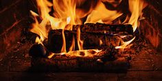 a fire burning in a fireplace with lots of flames