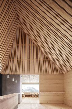 an empty room with wooden walls and ceiling