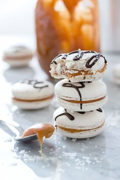 three donuts stacked on top of each other with chocolate drizzled on them