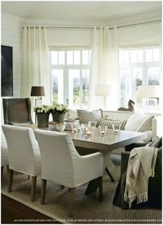 a living room filled with white furniture and lots of window sill curtains on the windowsill